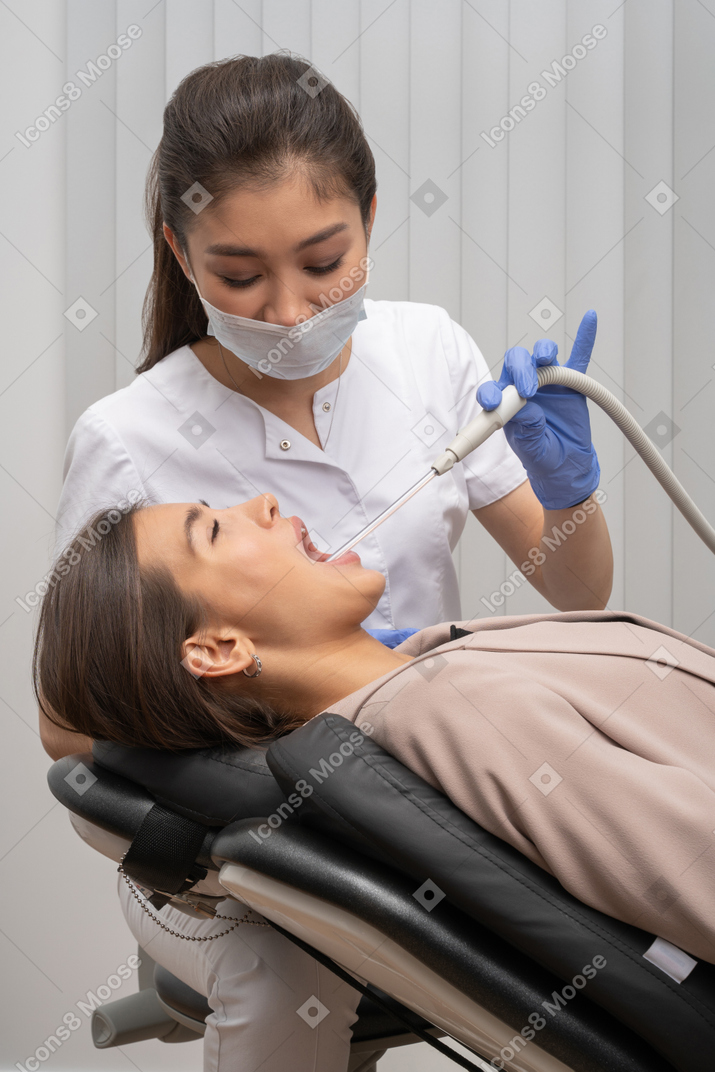 A woman getting her teeth checked by a dentist
