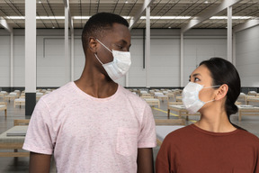 A man and a woman wearing face masks