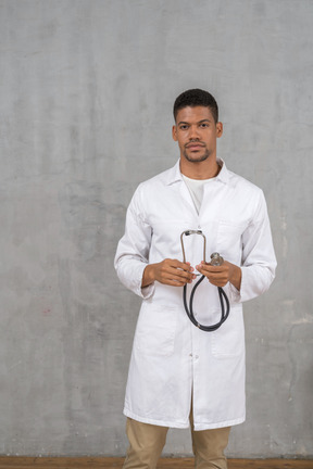 Médico masculino segurando um estetoscópio