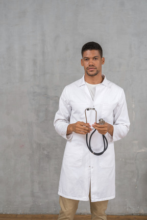 Male doctor holding a stethoscope