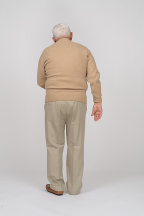 Rear view of an old man suffering from pain