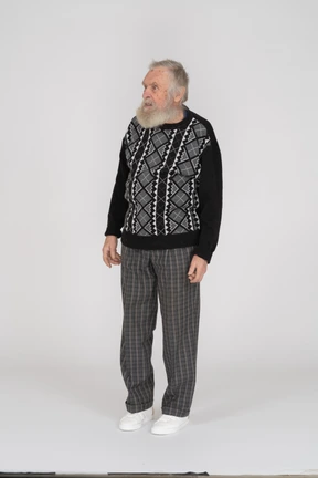 Old man standing with arms at sides and looking aside
