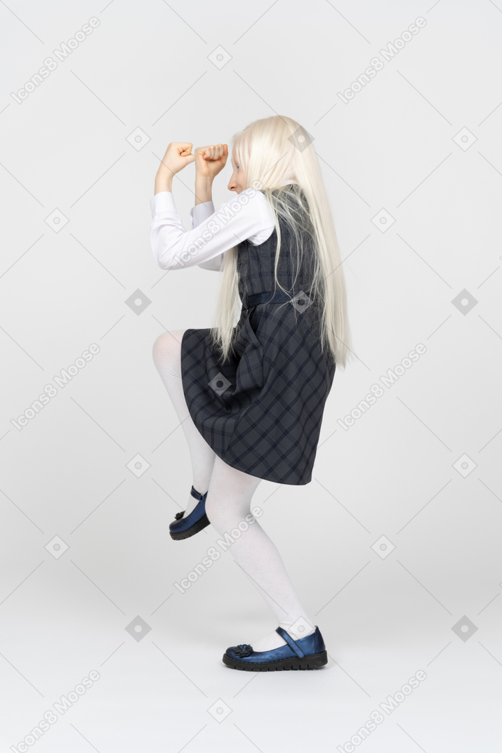 Back view of a schoolgirl celebrating