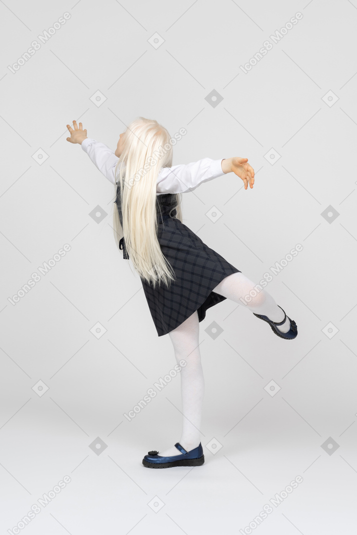 Schoolgirl practicing ballet moves