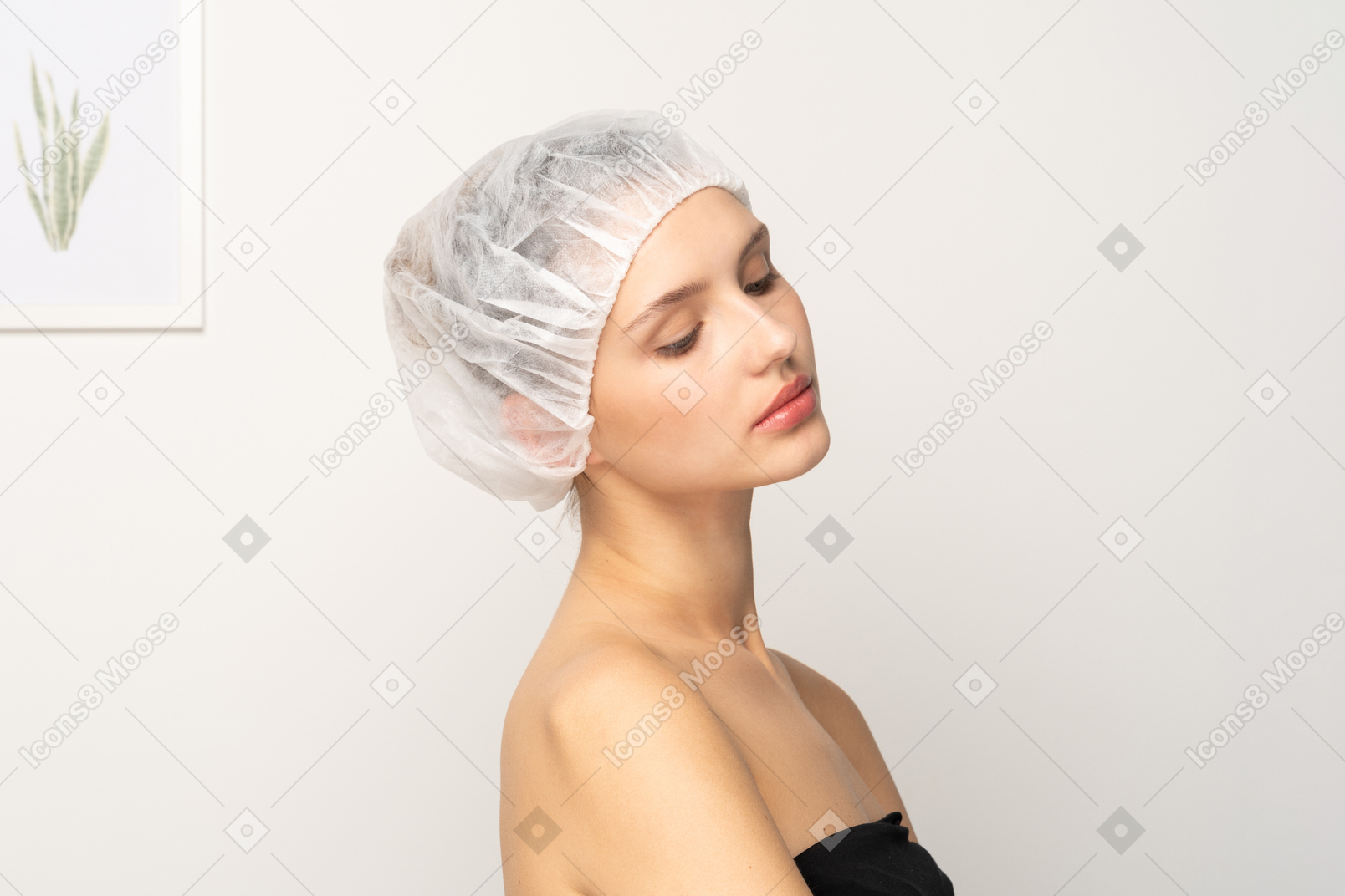Portrait of young female patient in medical cap looking down