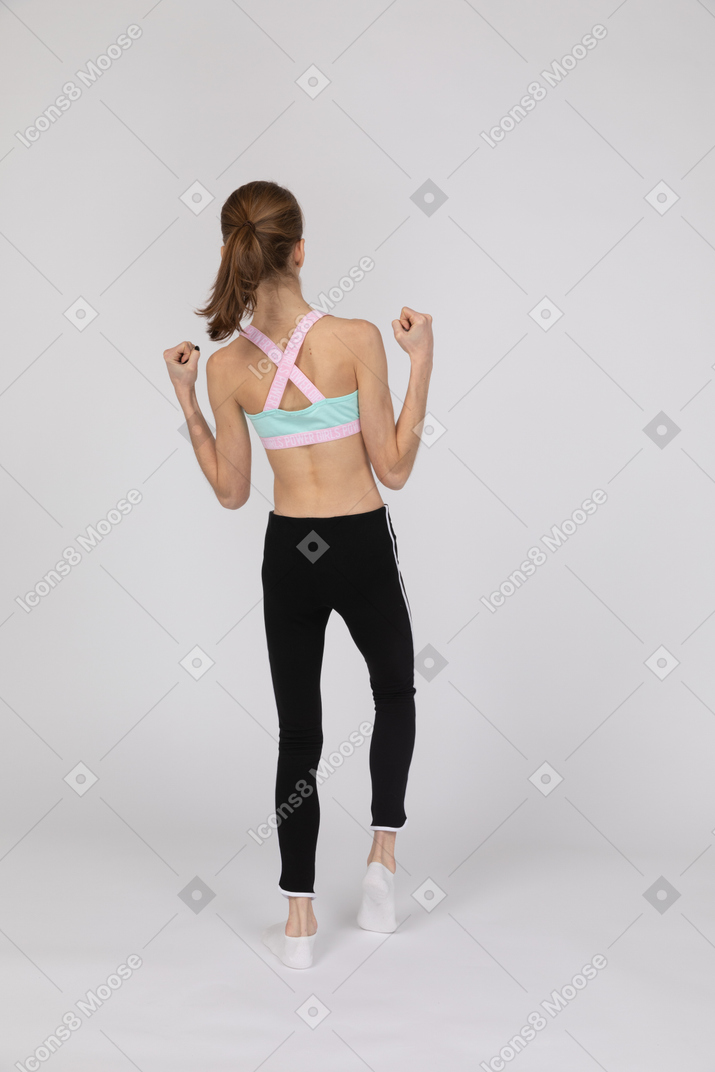 Back view of teen girl with clenched fists