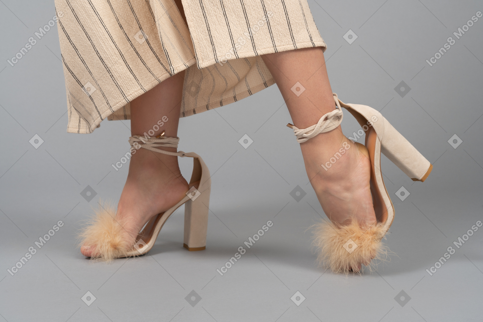 Female feet in over size fur heels