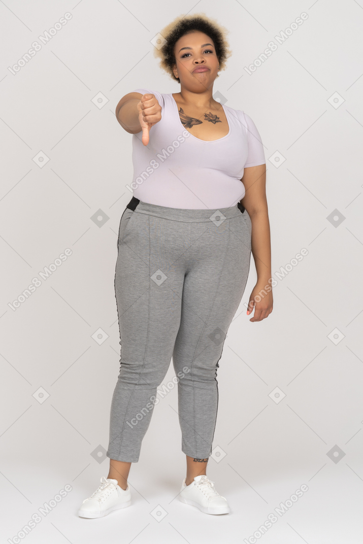 Displeased black woman showing a thumb down