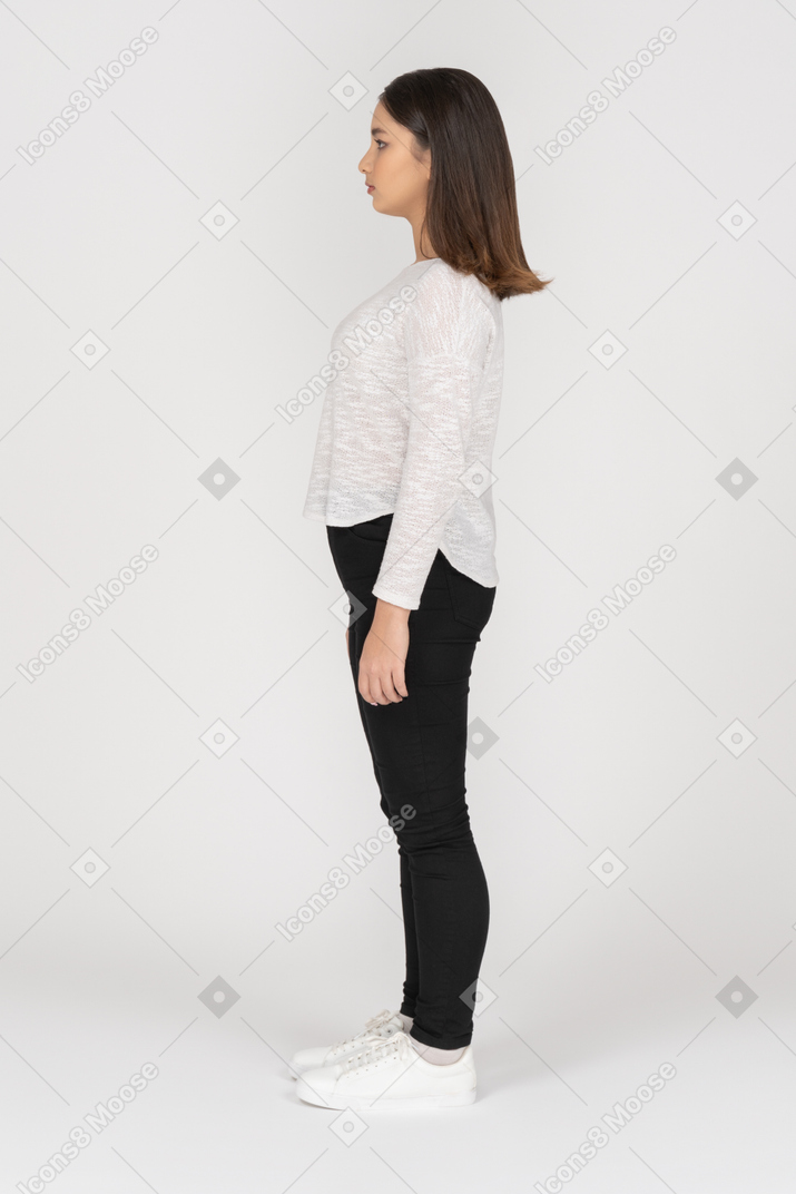 Young brown haired woman standing still in profile