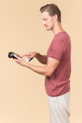 Young guy using a payment terminal