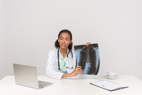 Beautiful female doctor with an x-ray photograph