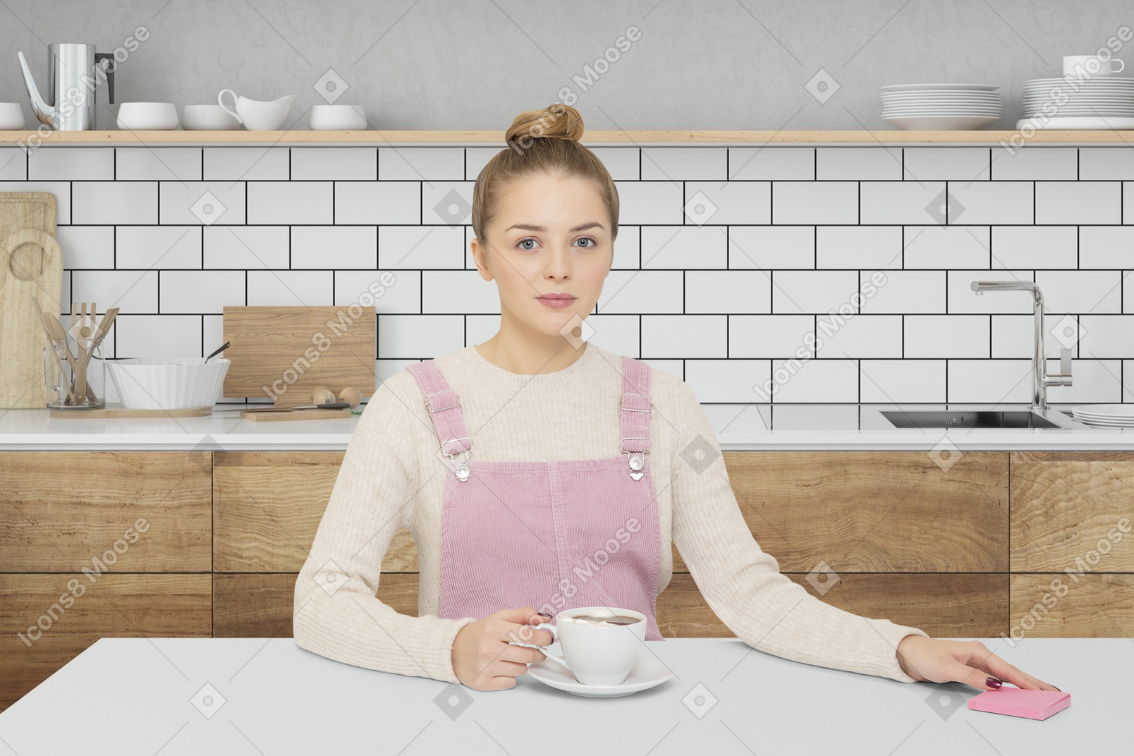 Young woman sitting at a table in a modern kitchen