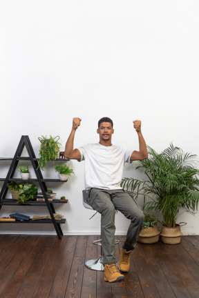 Good looking young man sitting on a chair