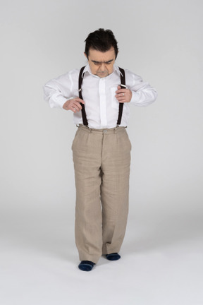 Middle-aged man adjusting suspenders