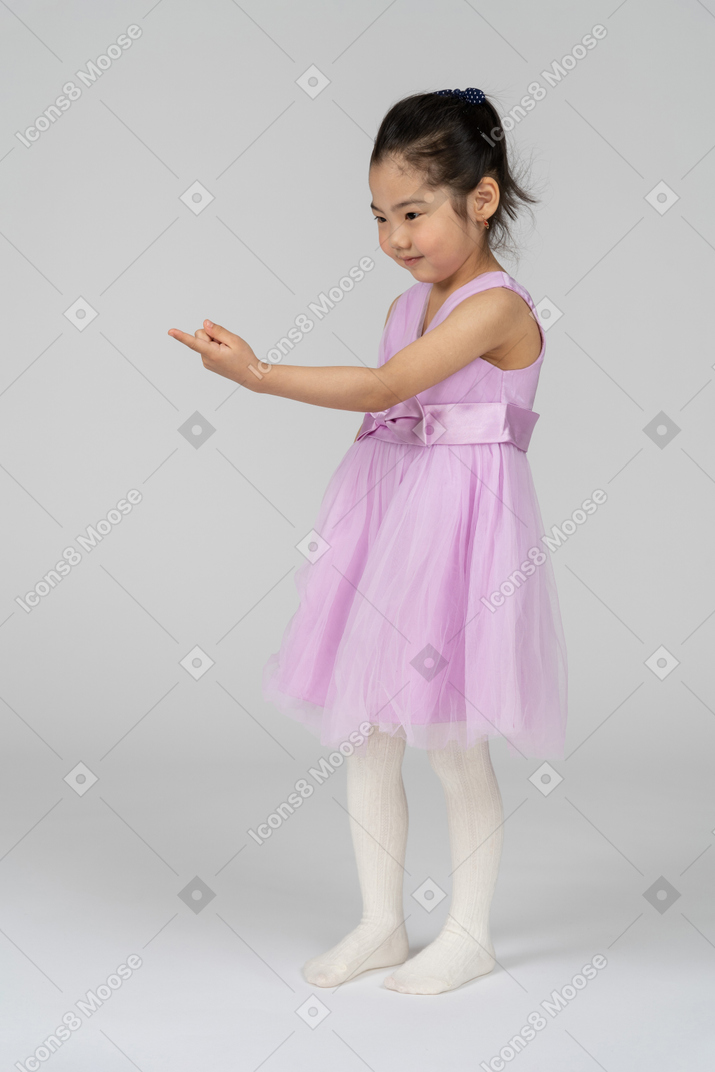 Retrato de una linda niña haciendo señas con su dedo