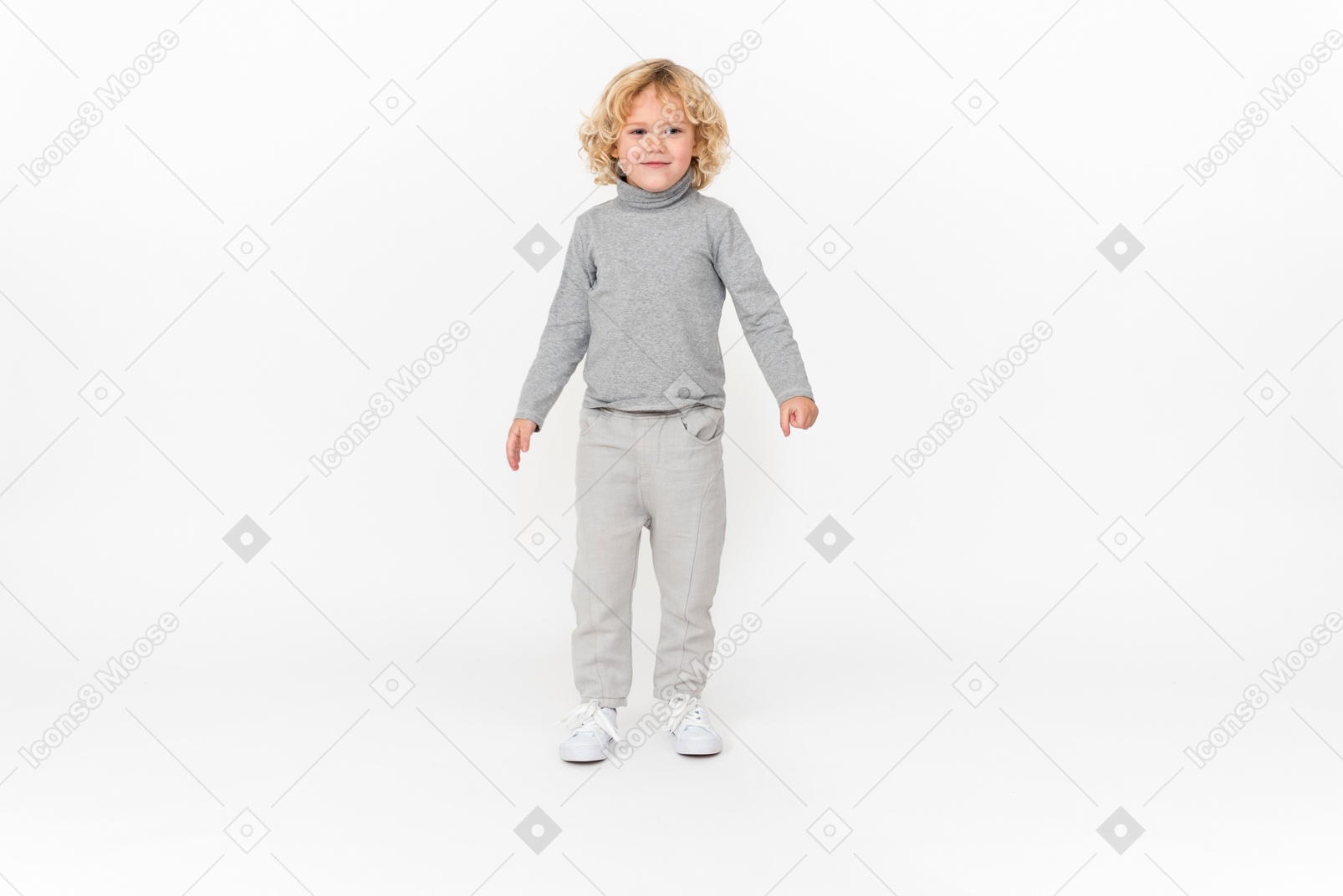 Adorable kid boy with arms at sides