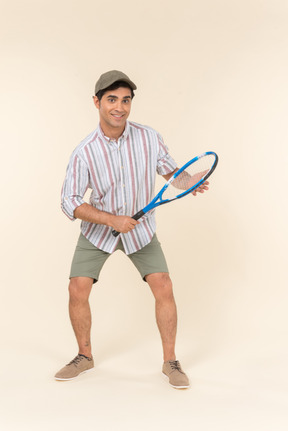 Young caucasian man holding tennis racket