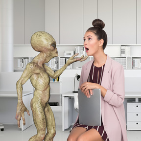 A woman sitting on a chair next to a statue of an alien