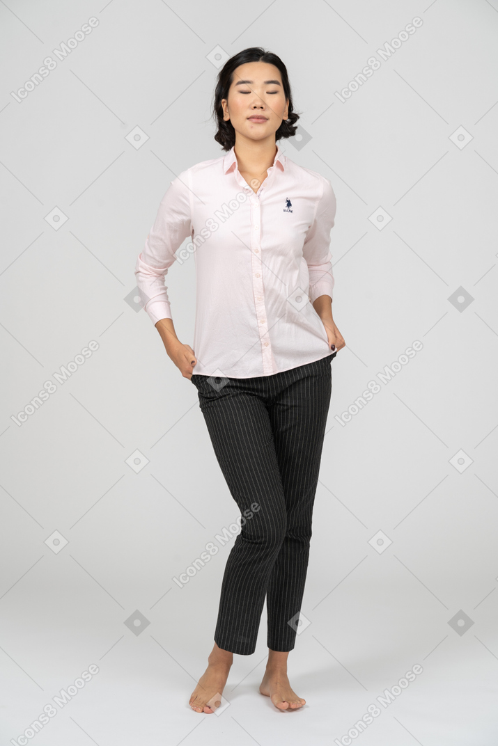 Female office worker posing with hands on hips