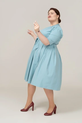 Happy woman in blue dress dancing