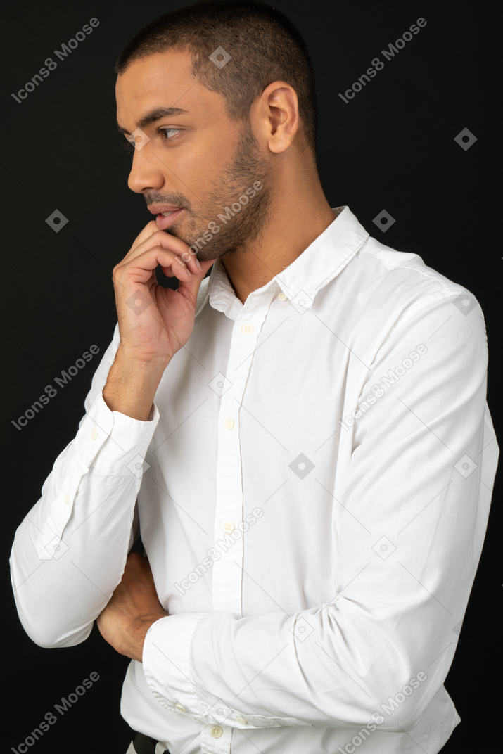 Attractive young man touching his chin