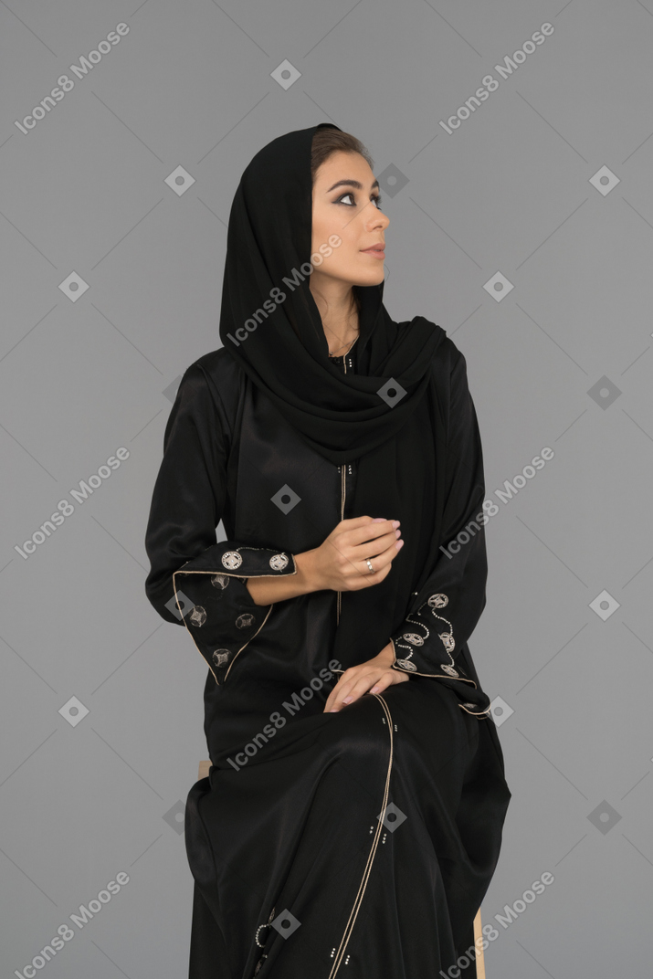 A covered arab woman looking up