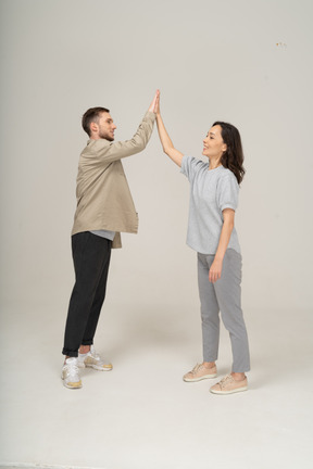 Young man and woman high-fiving