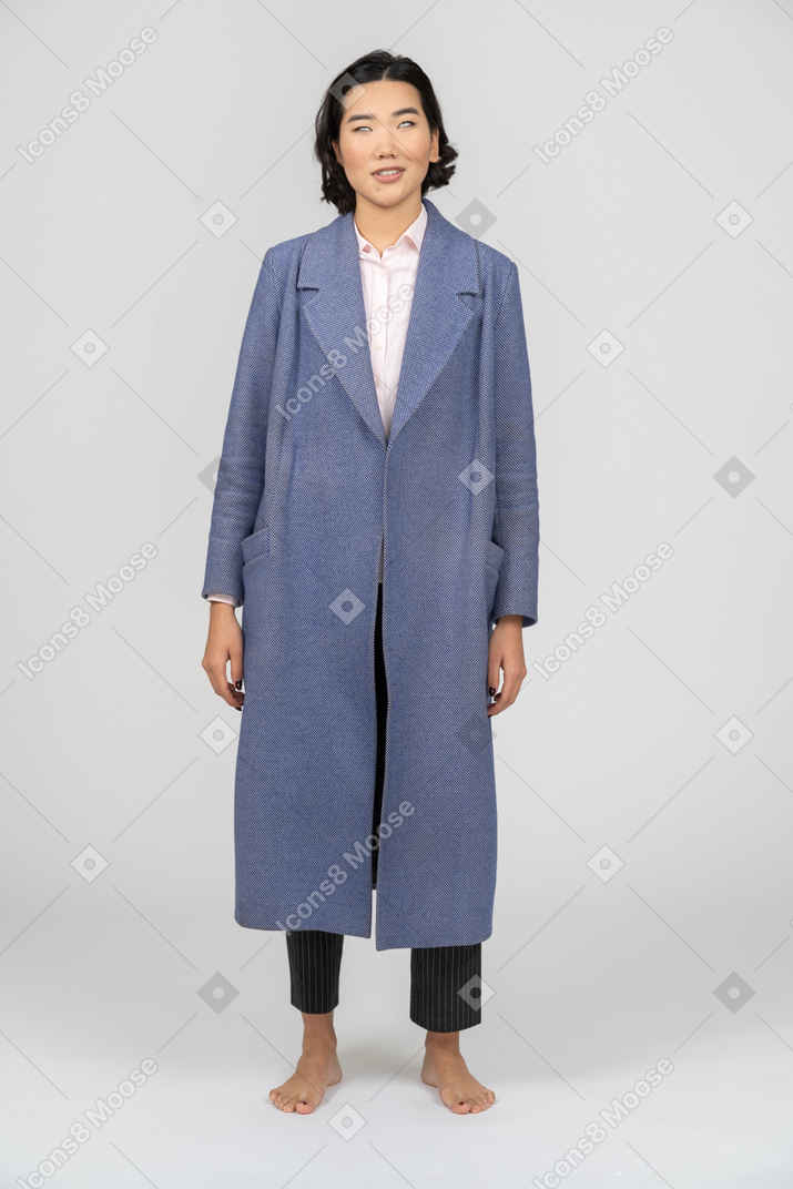 Woman in blue coat rolling her eyes