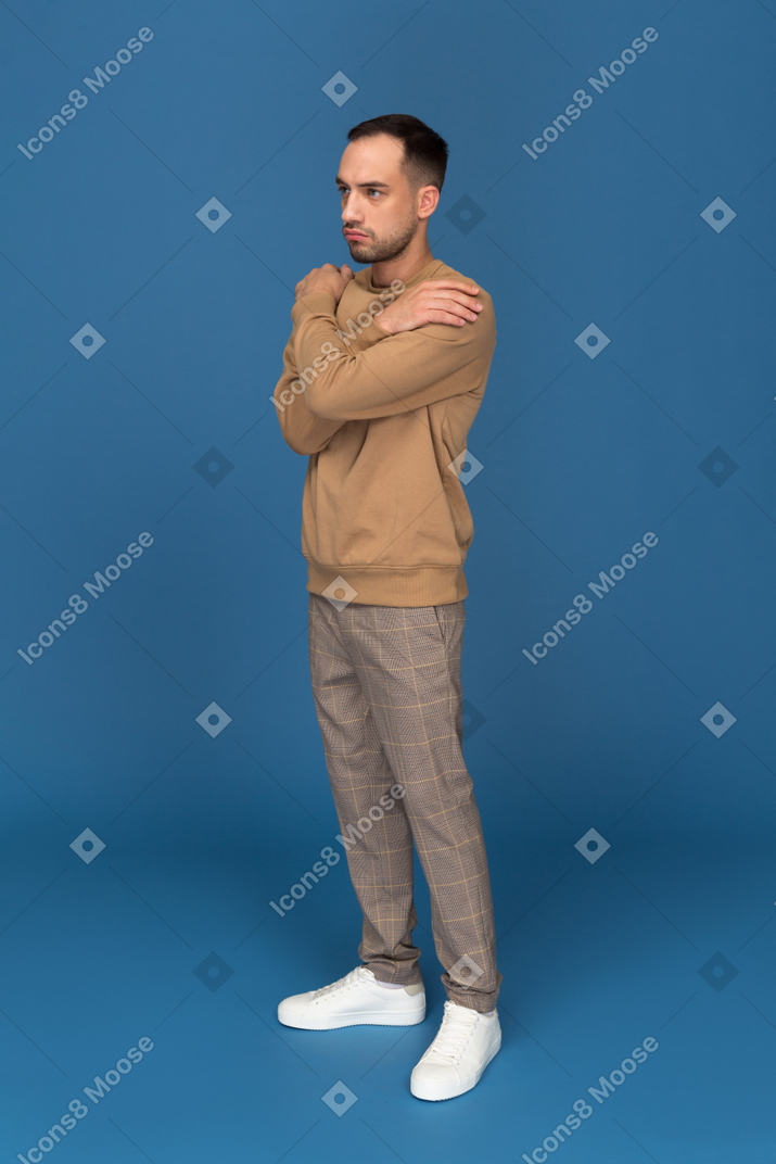 Serious man standing with hands crossed