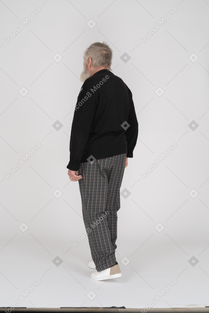Elderly man walking away from the camera