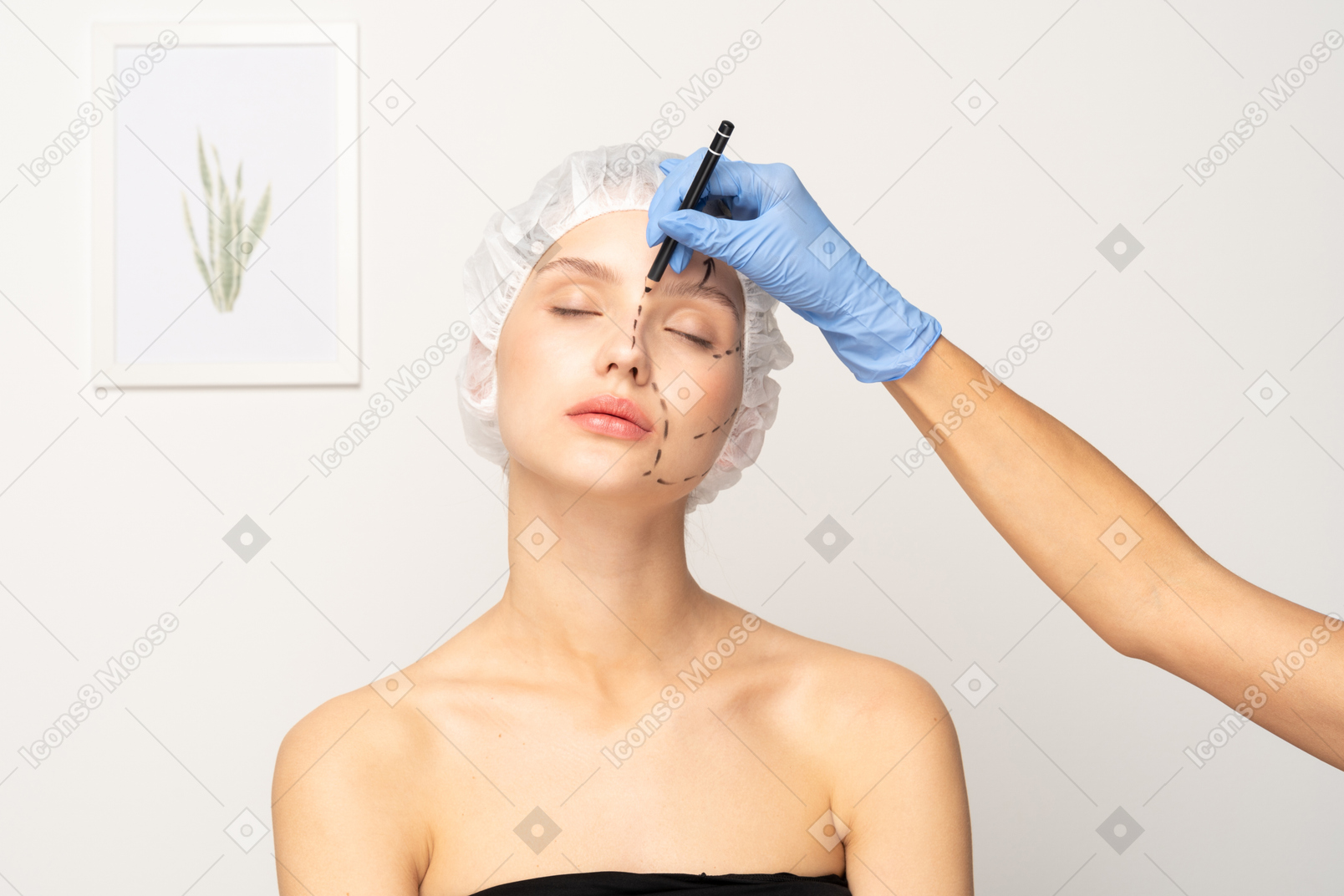 Young woman's face being marked for surgery