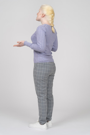 Three-quarter back view of a woman explaining and gesturing