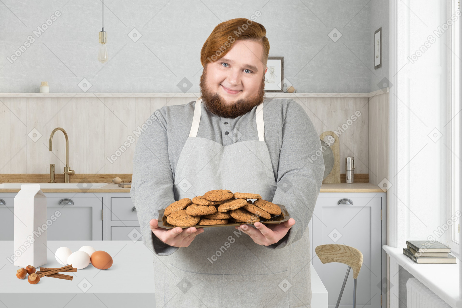 A man holding a plate of cookies in a kitchen