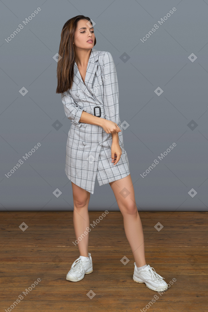 Confident young woman adjusting her dress sleeve