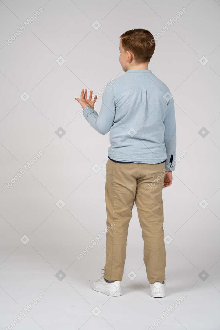 Back view of a boy explaining something