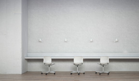 Room with white brick wall, narrow table and chairs