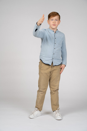 A young boy in a blue shirt and khaki pants