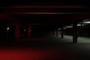 Dark underground car park with red light