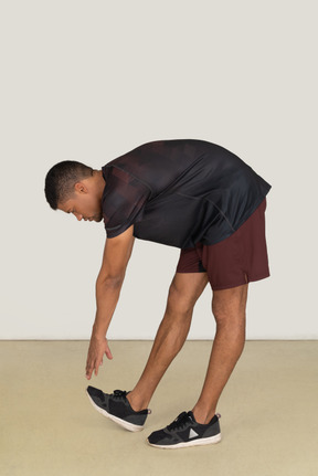 Young man in sports clothes exercising