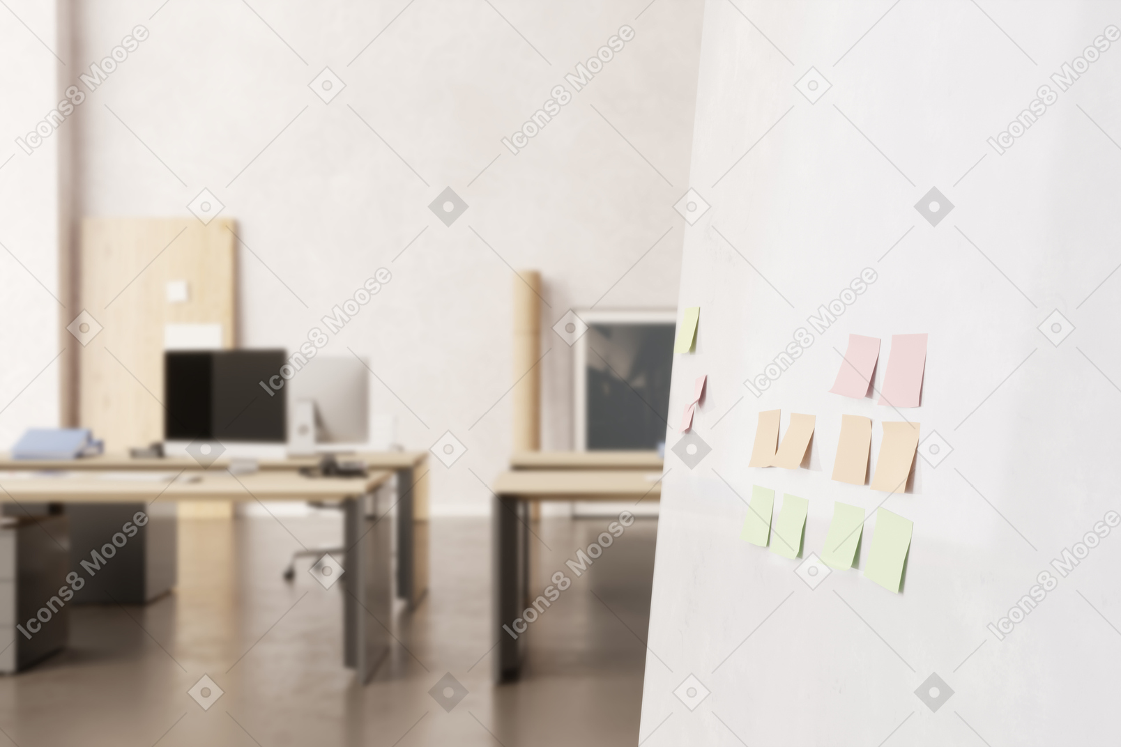 Pared blanca con notas adhesivas y escritorios de computadora en el fondo