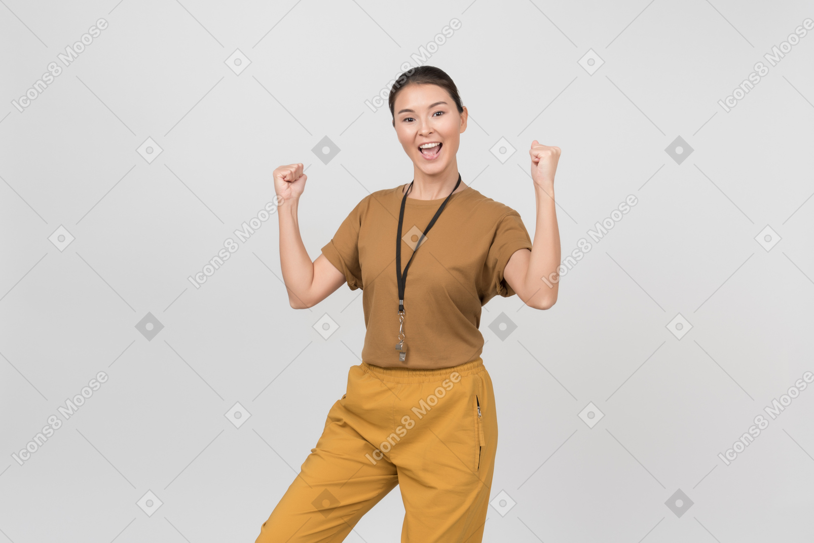 Young female pe teacher is excited and holding her hands up