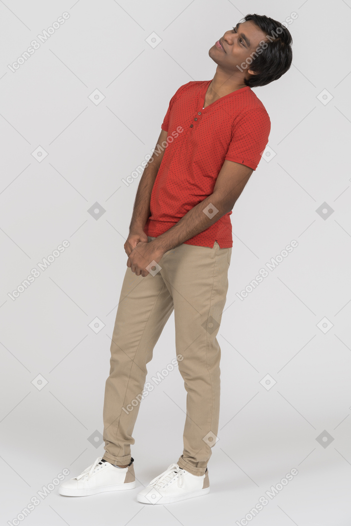 Young man looking away with folded hands