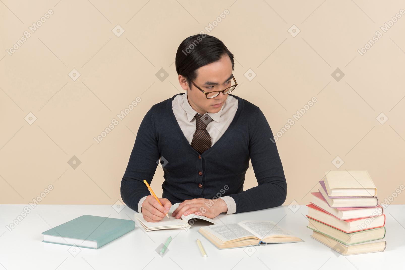 Joven estudiante asiática en un suéter escribiendo en un cuaderno