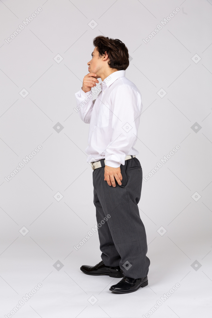 Side view of a male office worker thinking