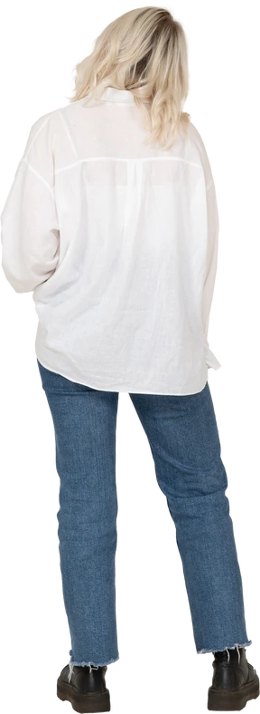 Back view of a blonde female in casual clothes  tilting head