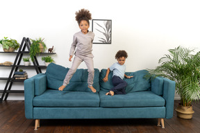 Good looking boy and girl play on the sofa