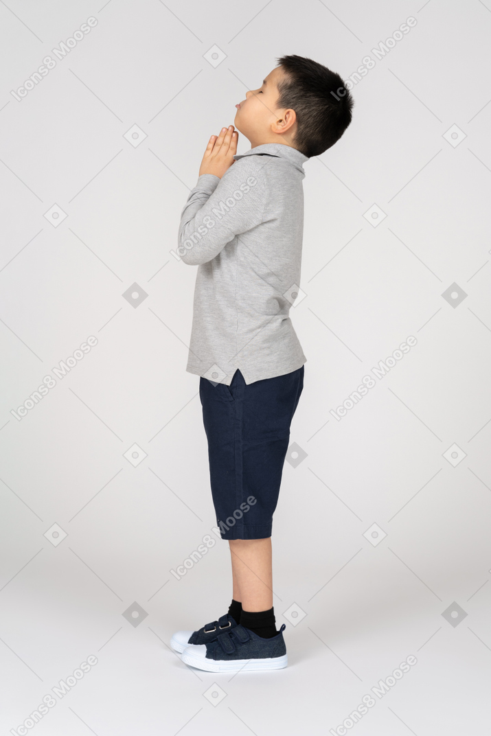 Boy praying in profile