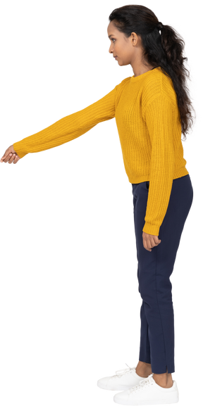 Side view of a girl in casual clothes pointing with arm
