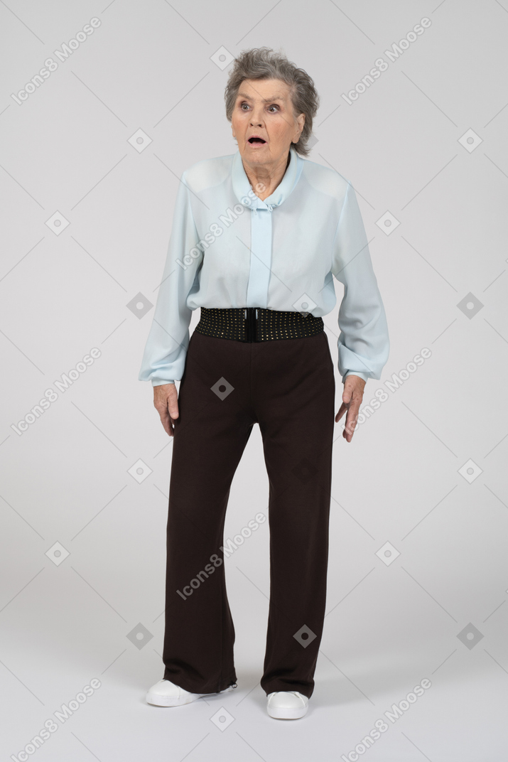 Front view of an old woman looking shocked to the left