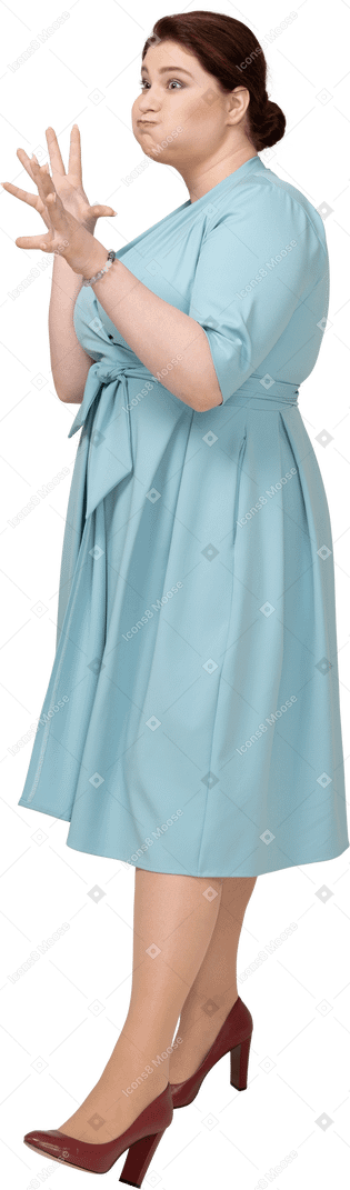 Side view of a woman in blue dress